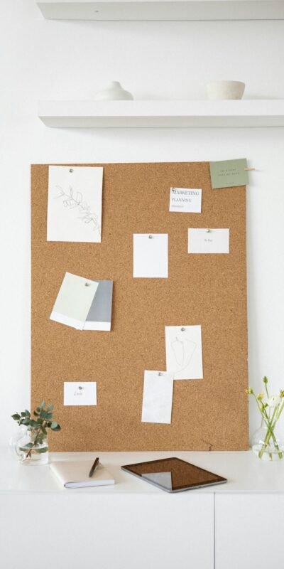 A clean and creative workspace featuring a cork board with notes, ideal for inspiration and design planning.
