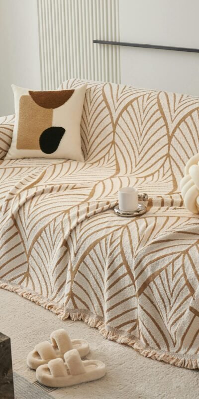 Stylish contemporary living room with a patterned sofa cover, cushion, and modern decor.